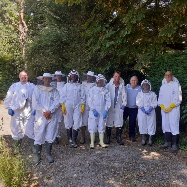 Beekeeping courses East Sussex: tutor with a group at Mantel Farm